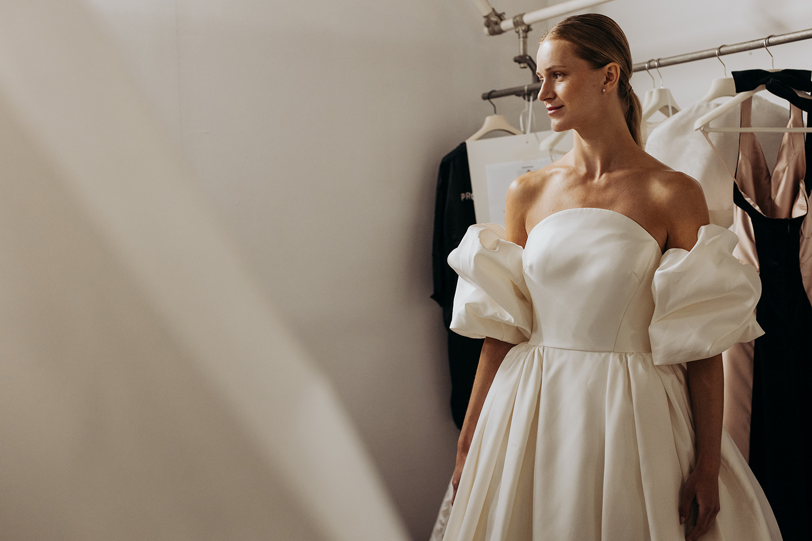 Backstage bridal week rail of gowns